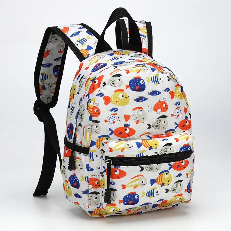 A cartoon kids backpack featuring colorful fish and sea creatures on a white background.