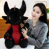 A woman is holding a black Toothless Dragon plush toy in a studio setting.