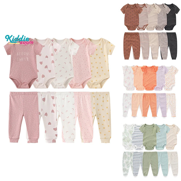 A collection of newborn bodysuits and pants in various pastel colors including pink, beige, and gray.