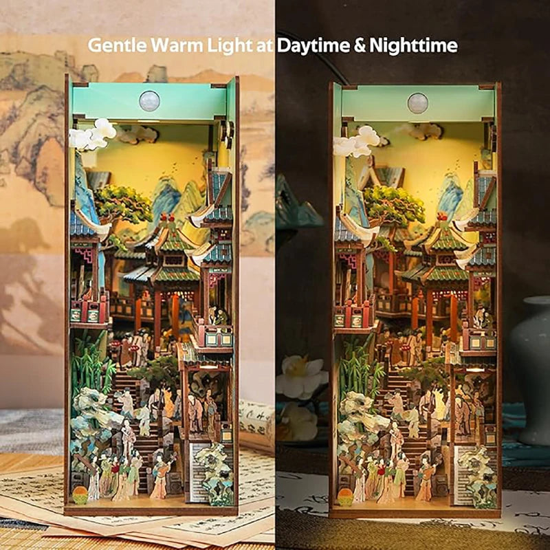 A wooden DIY book nook kit with intricate miniature scenes and LED lighting displayed in a vertical frame.