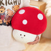 A red and white spotted mushroom plush toy is being held by a person, displayed against a light background.
