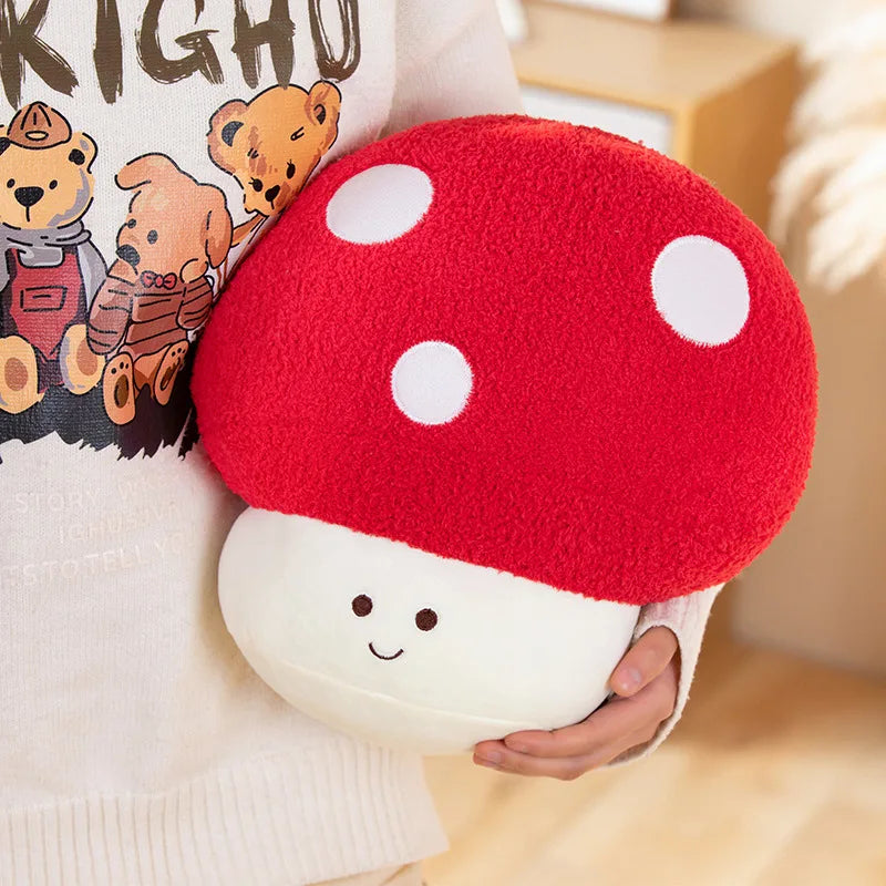 A red and white spotted mushroom plush toy is being held by a person, displayed against a light background.