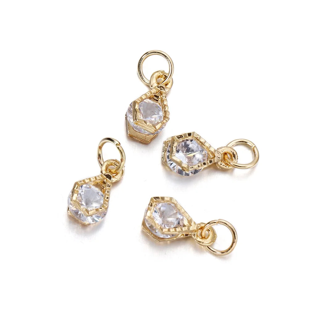 Gold-toned rhinestone heart charms for jewelry making, shown as individual pendants.
