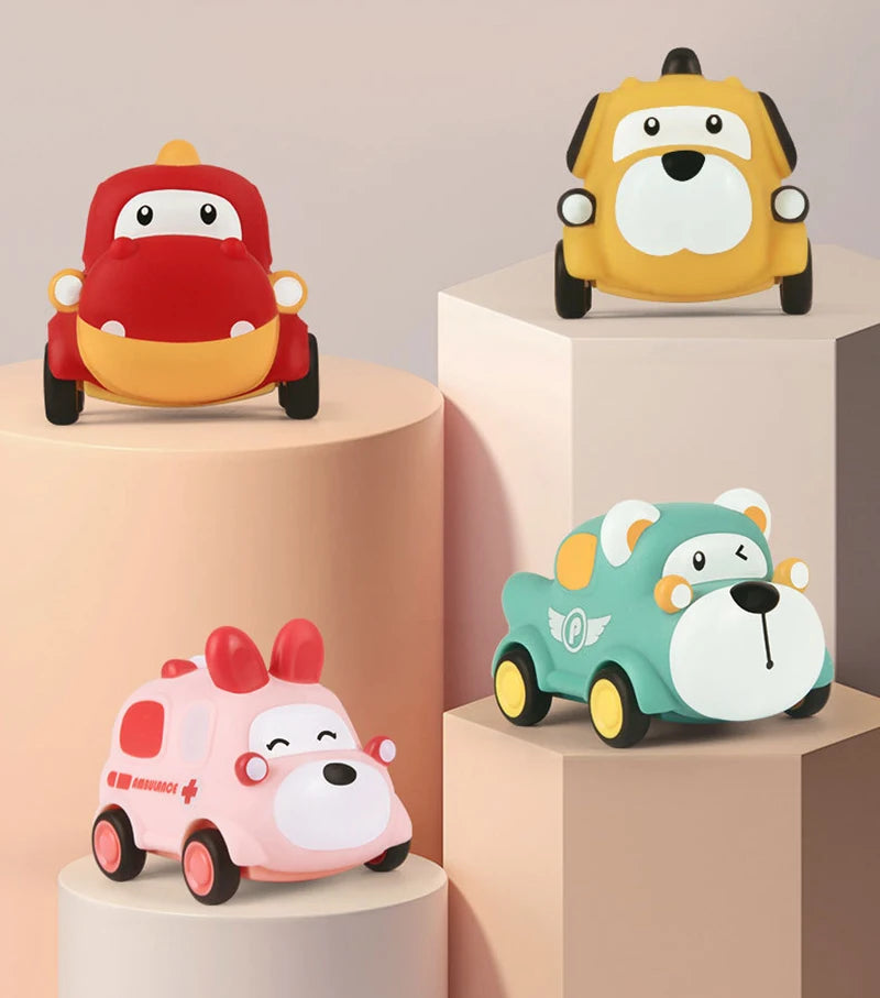 Three soft rubber pull-back toy cars in red, yellow, and mint green displayed on tiered stands.