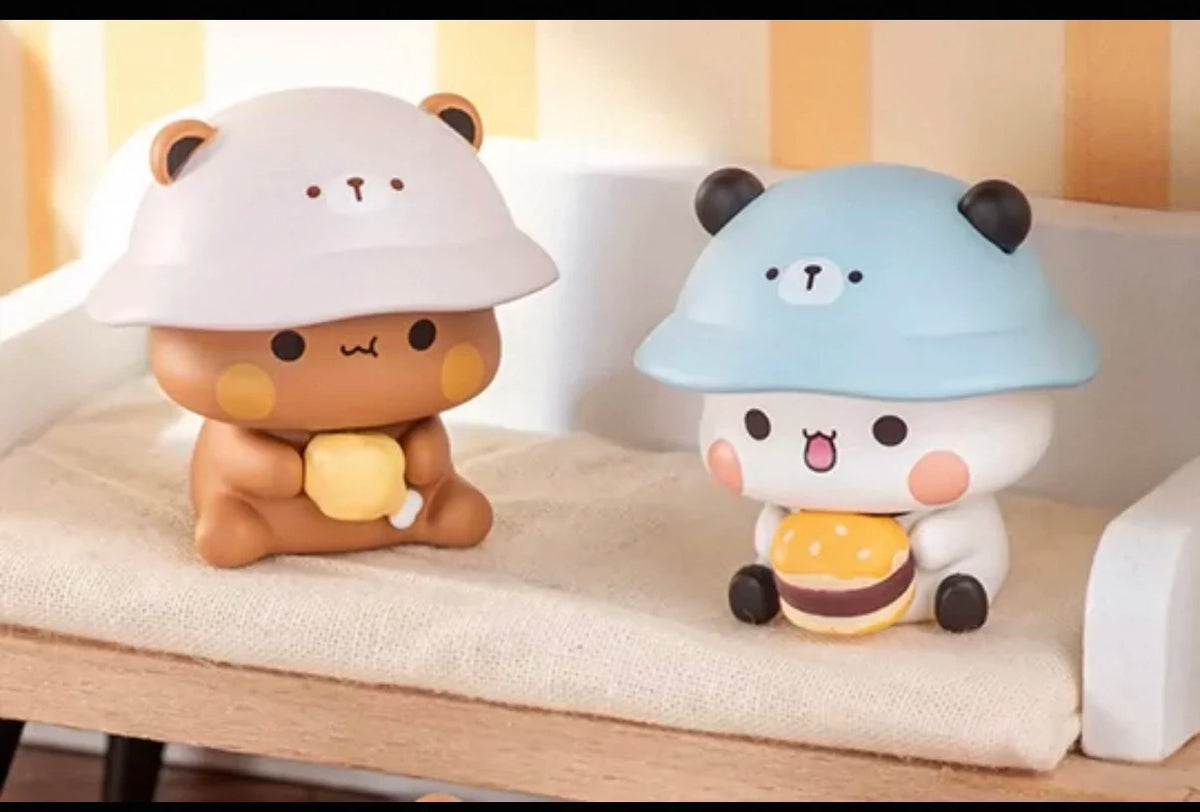 Dos figuras coleccionables de panda blind box, una con sombrero beige claro y la otra con sombrero azul claro.