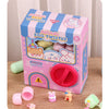 A box of Animal Egg Twister toys with pink and blue packaging and several plastic components scattered on a wooden surface.