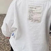 White long sleeve cotton tee with text printed on the chest