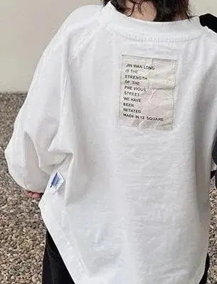 White long sleeve cotton tee with text printed on the chest