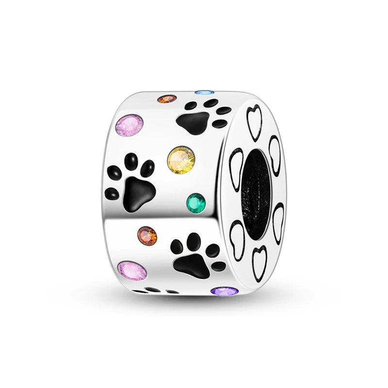 A silver bead featuring a heart shape and various colored gemstone accents including pink zircon and black stones.
