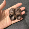 A pair of brown fashion slippers designed for 1/6 BJD dolls, shown in a hand.