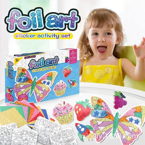 A child is holding a box of foil art sticker activity set with various colorful stickers and craft supplies.