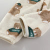 A beige fleece jacket and pants set featuring a repeating pattern of brown bears with green accents.