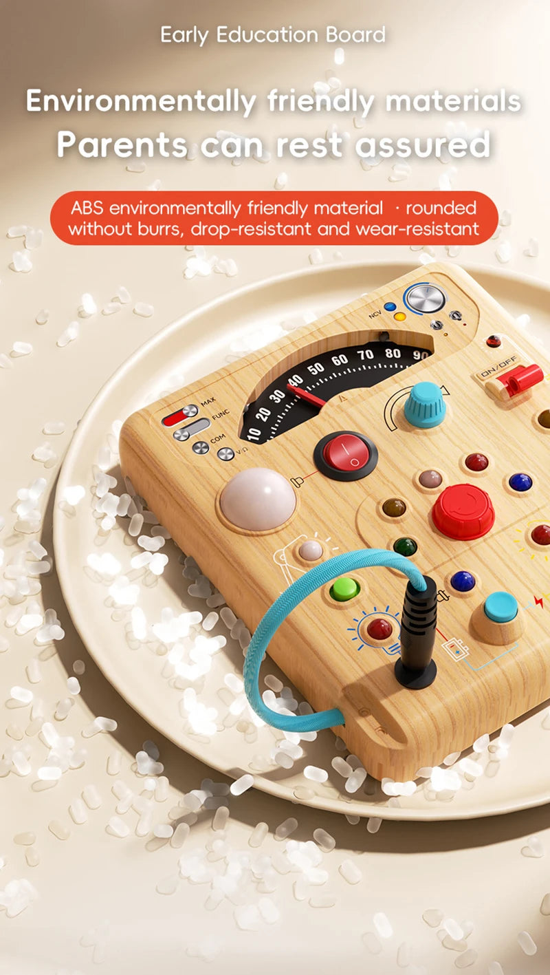 A wooden interactive circuit busy board with various buttons, lights, and switches resting on a plate.