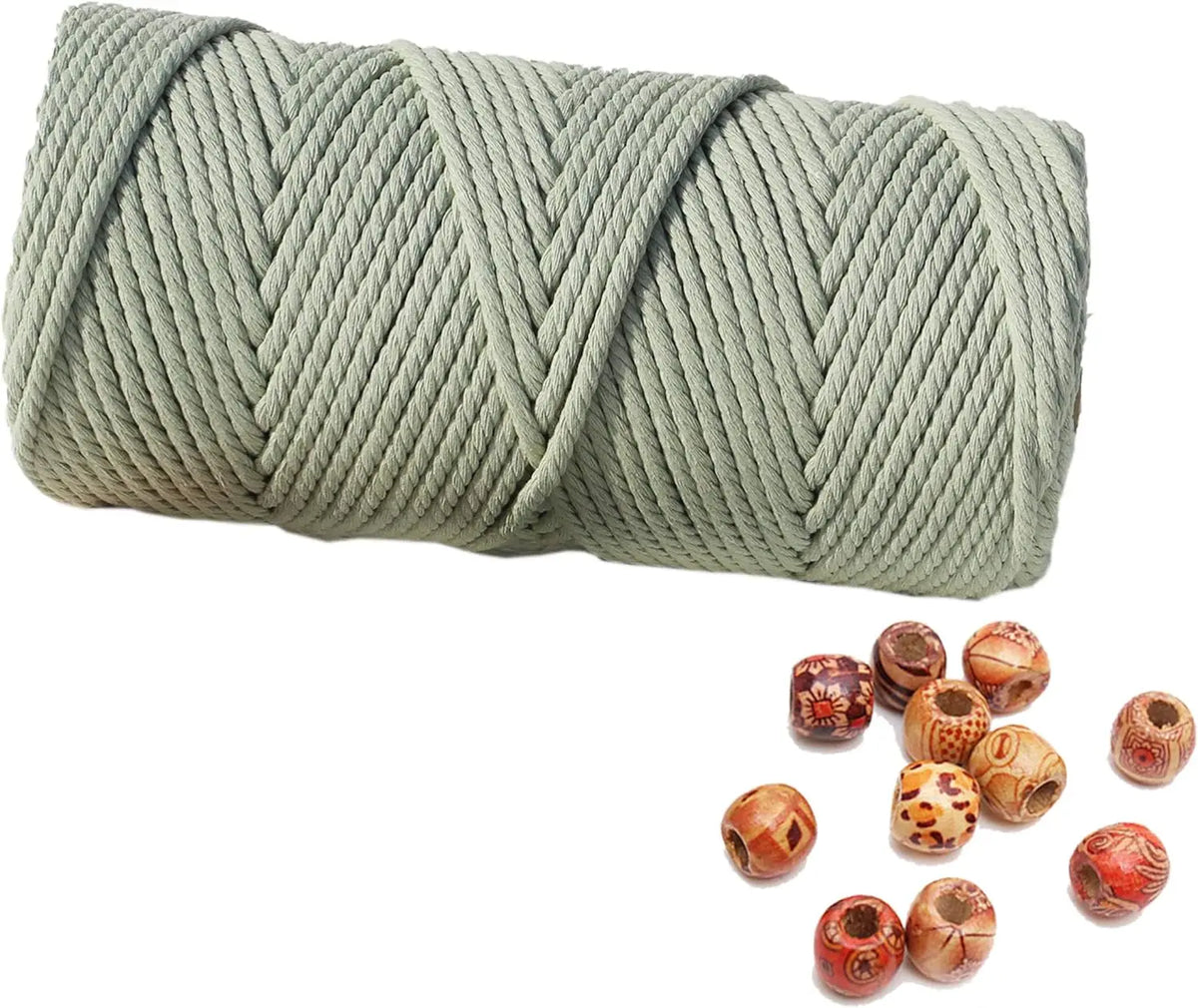 A skein of natural cotton macrame rope in a muted sage green color.