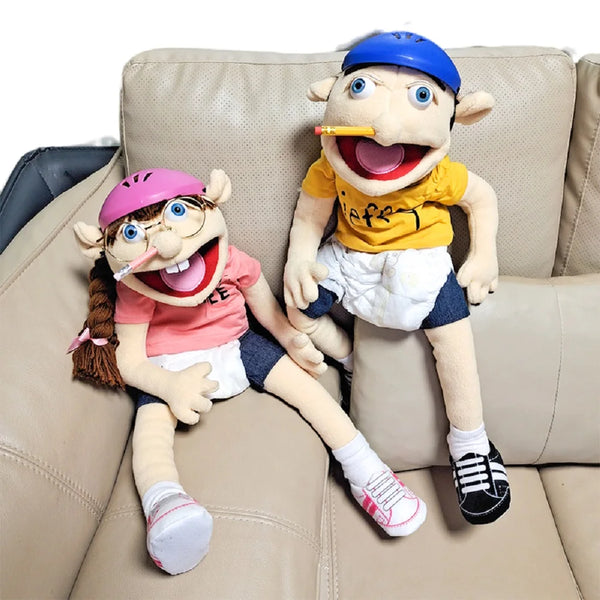 A plush toy of Jeffy featuring a blue hat and yellow shirt sitting on a light brown couch.