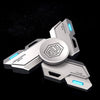 A silver metal fidget spinner with luminous blue accents and a central geometric design.