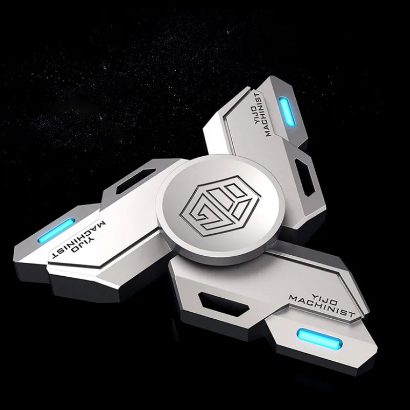 A silver metal fidget spinner with luminous blue accents and a central geometric design.