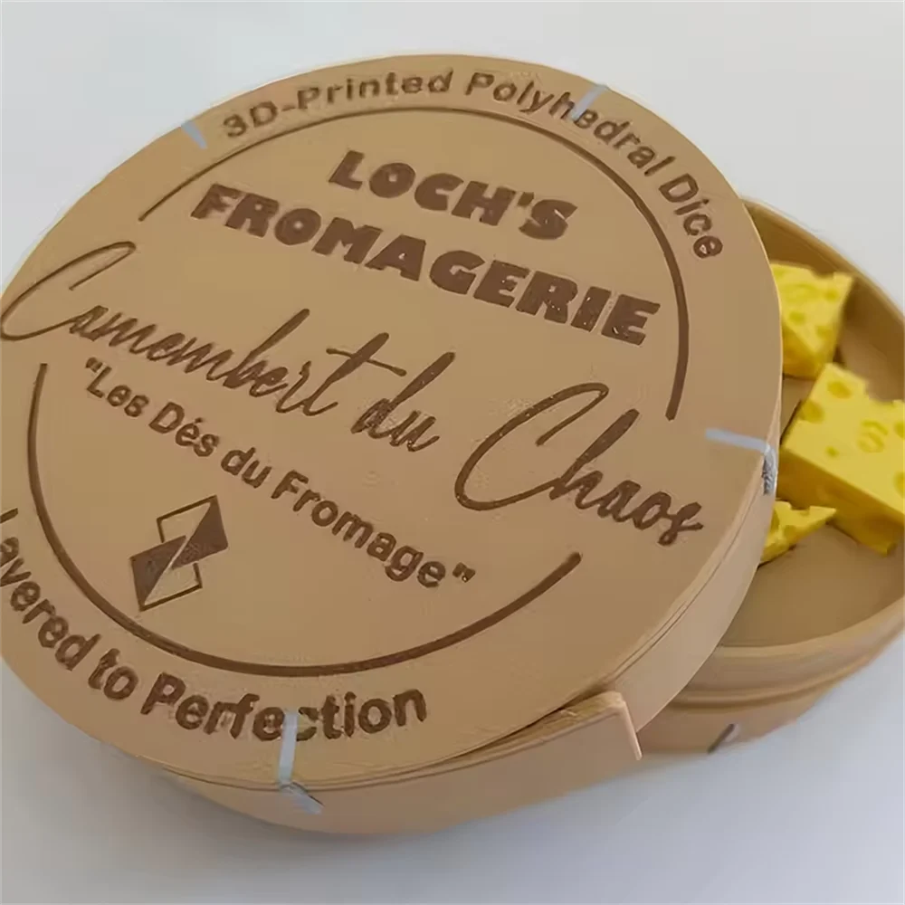 A 3D-printed polygonal die labeled Loch's Fromagerie with a cheese dice set and carrying case.