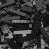 A pile of black building blocks and construction pieces for creative DIY projects.