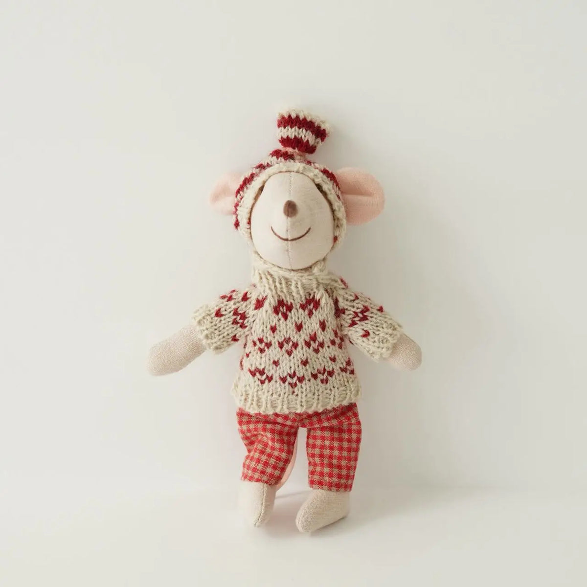 A handmade mouse plush doll with a red and white knitted outfit and a matching red checkered pants.