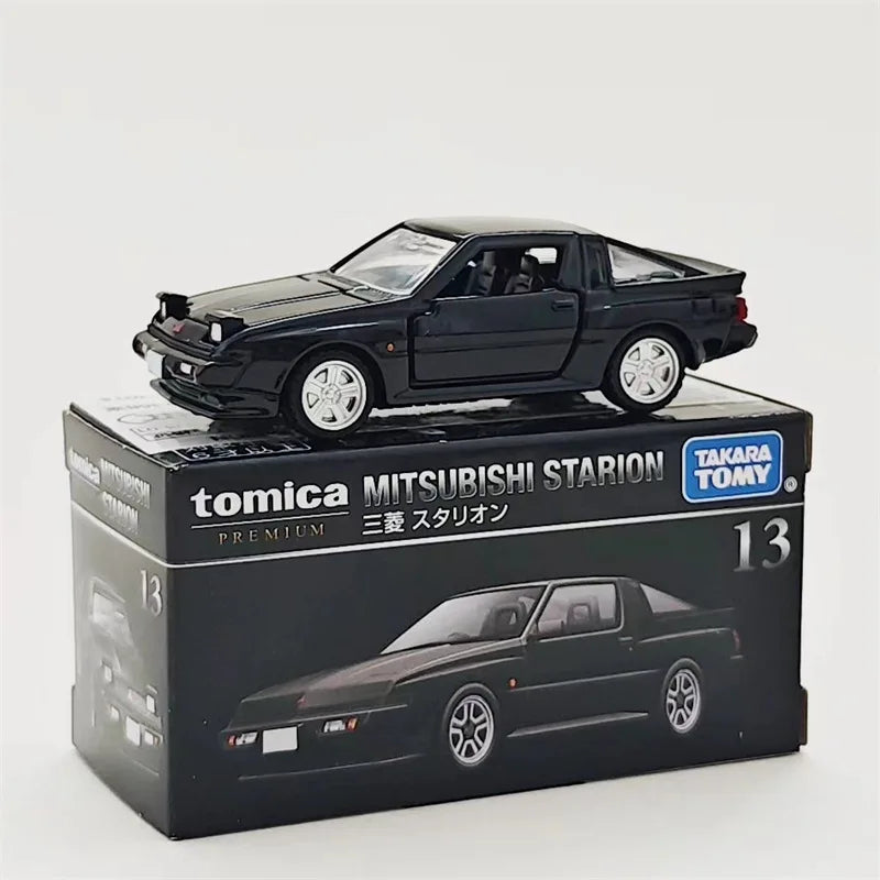 A black Tomica Mitsubishi Starion die-cast model car in its packaging box.