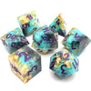 A set of seven resin polyhedral dice featuring teal and purple colors with gold accents.
