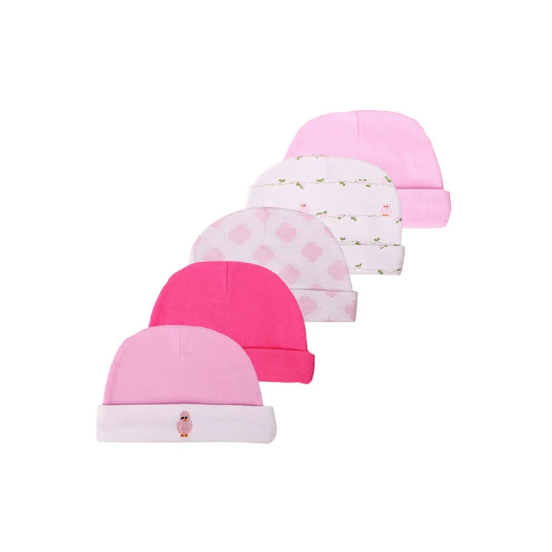 A stack of pink and magenta cartoon baby hats for infants.