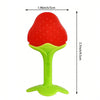 A bright red, fruit-shaped silicone baby teether with a yellow handle and green base.
