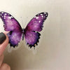 A purple butterfly sticker with black and white markings is shown against a light background.