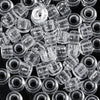 A close-up view of a pack of clear, round pony beads for jewelry making and craft projects.