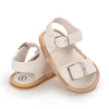 A pair of beige breathable baby first walker sandals with soft anti-slip soles.