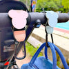 Stroller organizer hooks made of PU leather attached to a stroller handlebar.
