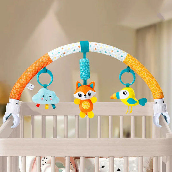 An infant sensory arch toy featuring an orange and white arch with hanging toys including a cloud, a fox, and a yellow bird.
