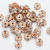 A pile of rose gold crystal rondelle spacer beads for jewelry making.