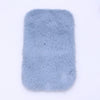 A rectangular, light blue faux fur mat designed for dollhouse decor.