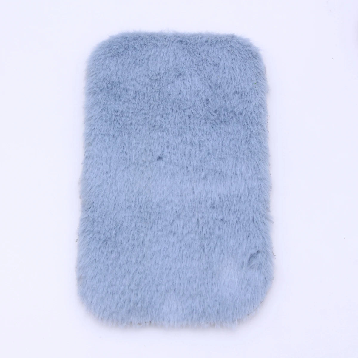 A rectangular, light blue faux fur mat designed for dollhouse decor.