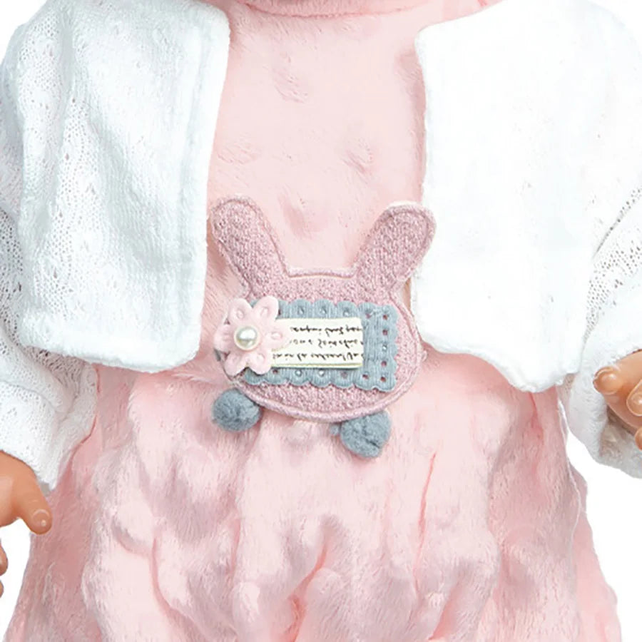 A pink doll outfit set featuring a shirt with a cat print design and white and light pink layered fabric.