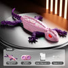 A pink and purple wall-climbing gecko remote control toy is displayed on a dark surface with accessories.