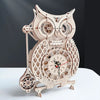 A detailed wooden owl wall clock made from a DIY assembly kit, featuring intricate carvings and gears.