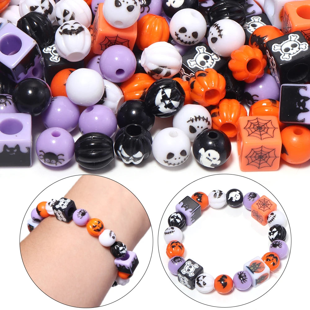 A collection of black, white, orange, and purple acrylic beads used for DIY jewelry and crafts.