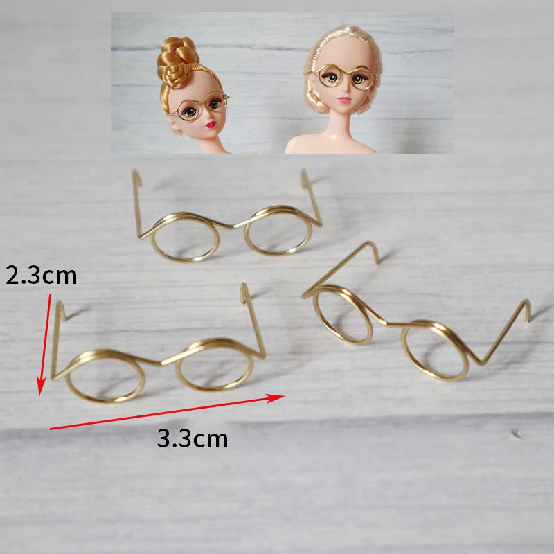 A set of five metal round glasses frames for dolls, including a pair and two models.