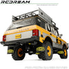 A yellow RC Range Rover model with black accessories and mud flaps for an upgrade kit.