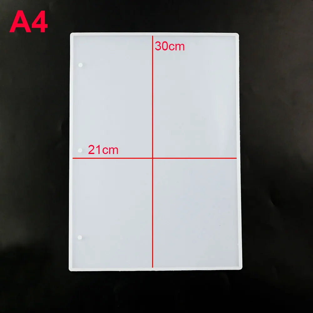 A white rectangular silicone mold for an epoxy resin notebook cover, marked with dimensions 30cm and 21cm.