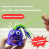 A purple monster stress relief toy with green hair is being pulled on by a green string.