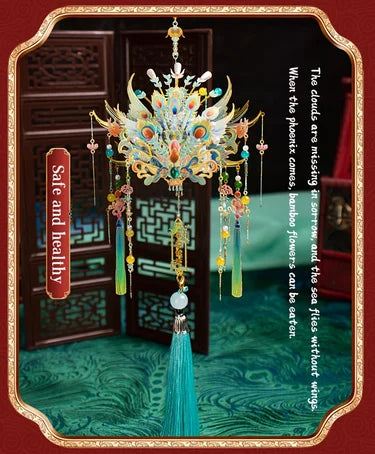 A detailed 3D metal phoenix crown model kit with colorful feathers and dangling elements displayed on a dark background.