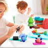 A young girl is crafting with a 24-color polymer clay set and carving tools on a white table.