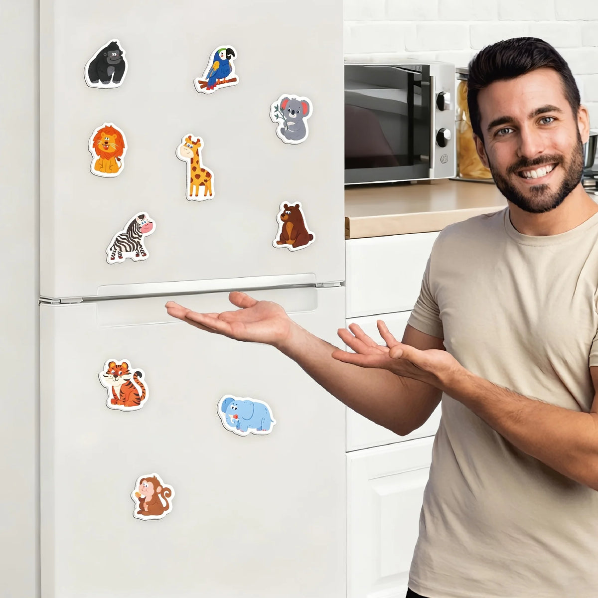 A man is displaying a set of ten colorful animal fridge magnets on a white refrigerator.