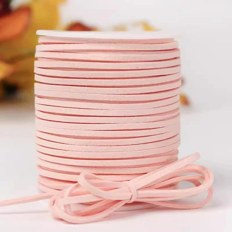 A stack of pink velvet faux suede braided ribbon rolls for crafting and gift wrapping.