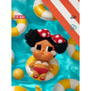 A vinyl figure of a woman with dark curly hair and large eyes wearing a red polka-dot bow, surrounded by yellow and white str