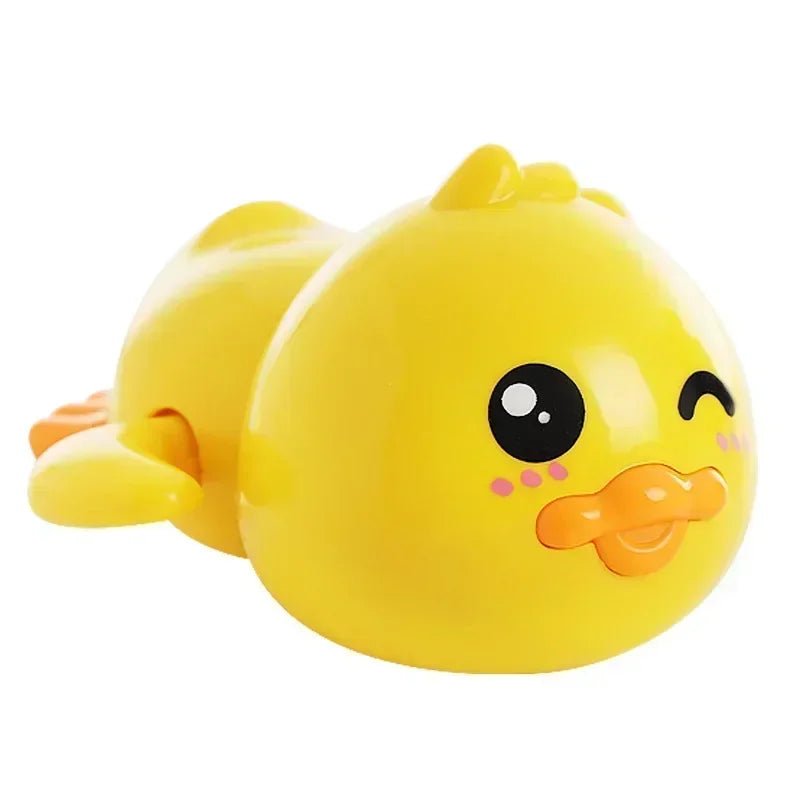 A bright yellow wind-up swimming duck bath toy for toddlers with black eyes and an orange beak.